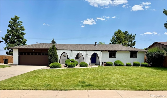 4192 S Vrain St, Denver, CO 80236 - ranch-style home with a garage, driveway, a front lawn, and brick siding