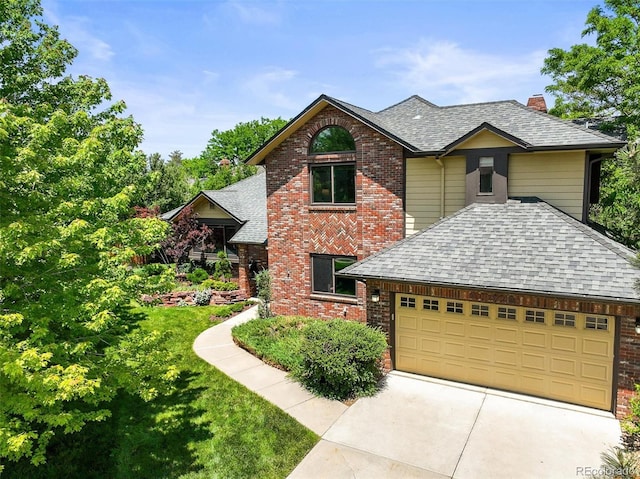 11072 Zephyr St, Broomfield, CO 80021 - traditional-style home with roof with shingles, a chimney, and brick siding