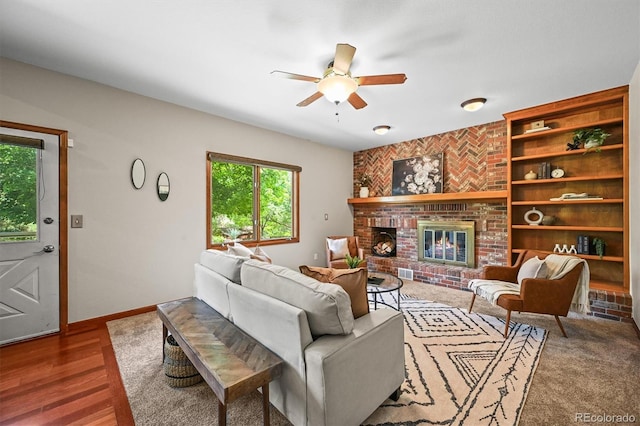 11072 Zephyr St, Broomfield, CO 80021 - living room with ceiling fan, baseboards, a brick fireplace, built in shelves, and wood finished floors