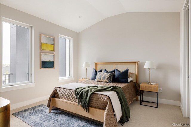 bedroom with vaulted ceiling, light carpet, and baseboards