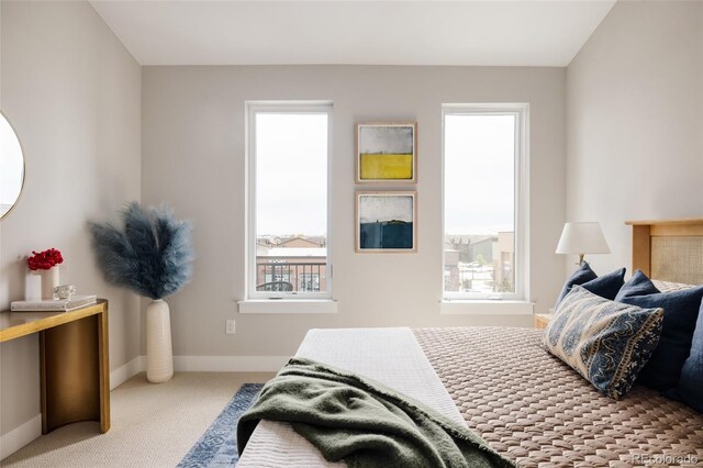 bedroom with carpet flooring and baseboards