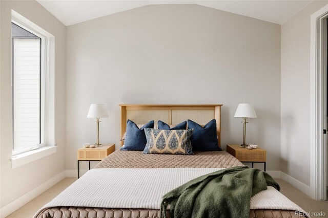 bedroom featuring carpet flooring, vaulted ceiling, and baseboards