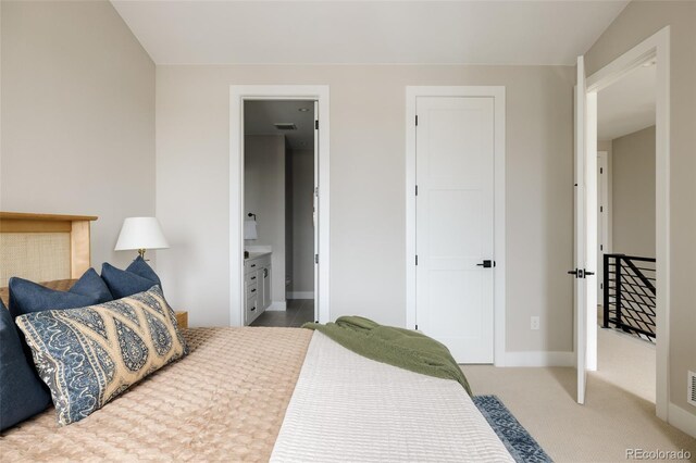 bedroom featuring baseboards, carpet, and ensuite bathroom