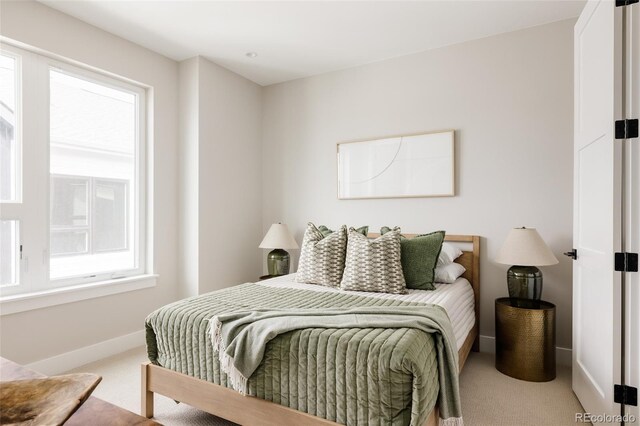 carpeted bedroom featuring baseboards
