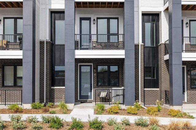 entrance to property featuring brick siding