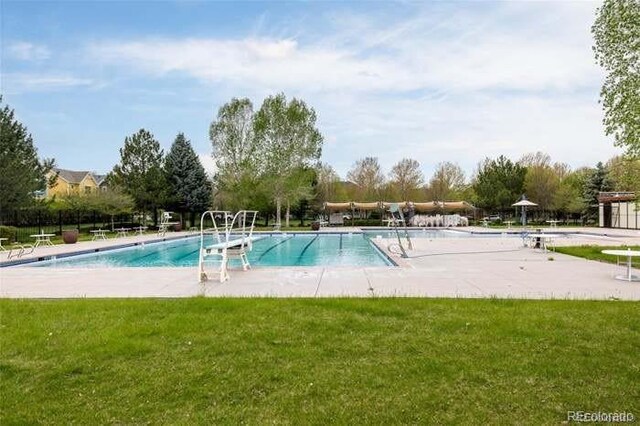 community pool featuring a lawn