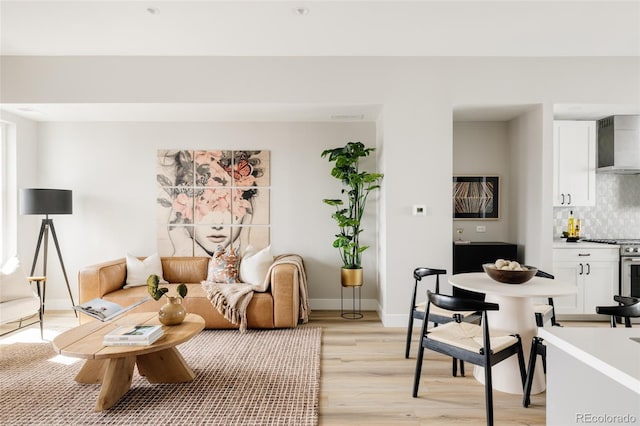 living room featuring light wood finished floors and baseboards