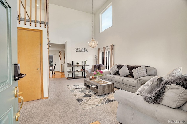 carpeted living room featuring high vaulted ceiling and an inviting chandelier