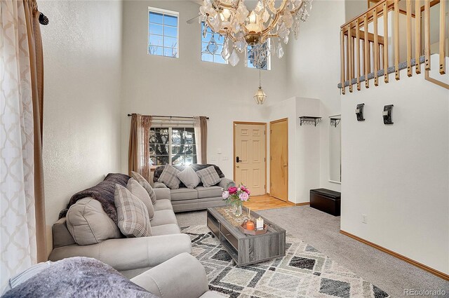 carpeted living room with an inviting chandelier