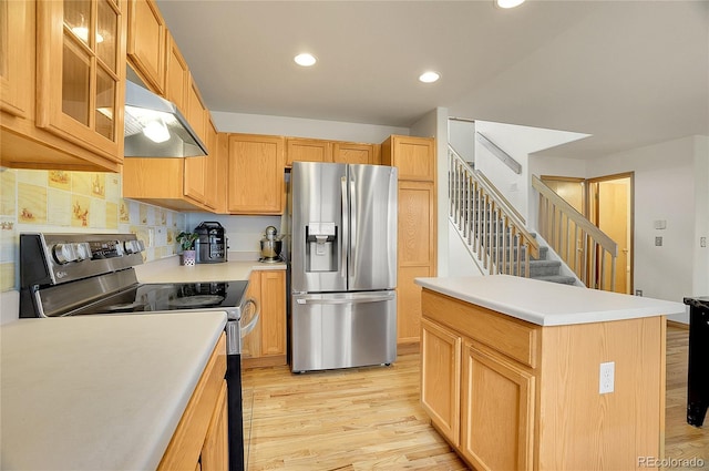 kitchen with light hardwood / wood-style flooring, range hood, backsplash, light brown cabinetry, and appliances with stainless steel finishes