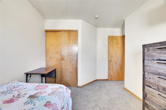 bedroom with a closet and light colored carpet