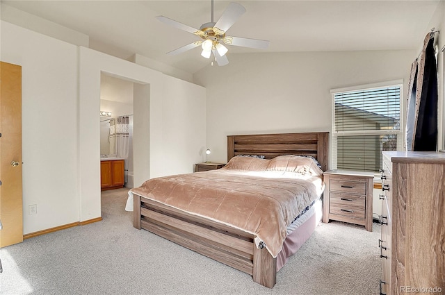 carpeted bedroom with ensuite bathroom, ceiling fan, and lofted ceiling