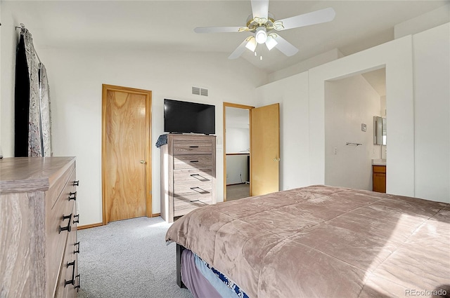 bedroom featuring ceiling fan, light colored carpet, lofted ceiling, and ensuite bath