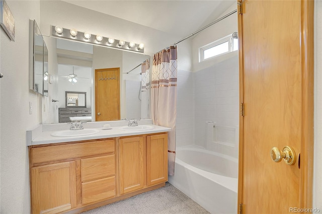 bathroom featuring vanity, shower / bathtub combination with curtain, and ceiling fan