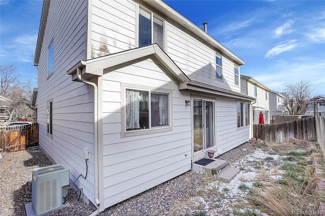 rear view of house featuring central AC