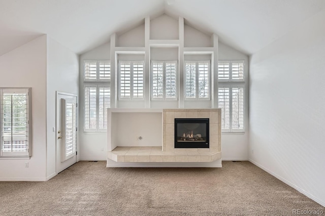 unfurnished living room featuring carpet, lofted ceiling, and a fireplace