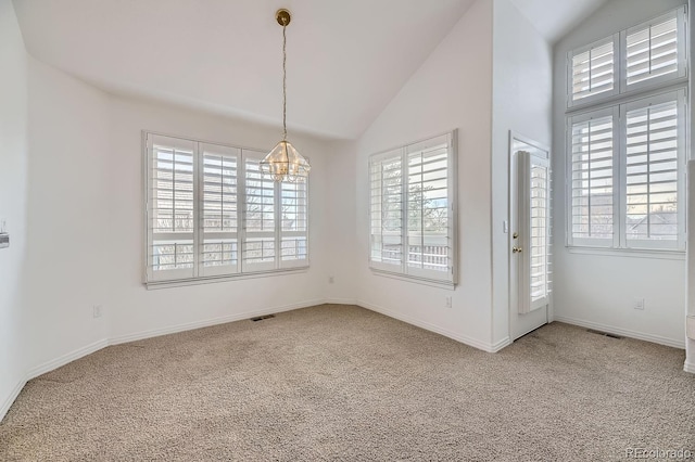 unfurnished dining area with carpet, lofted ceiling, and a notable chandelier