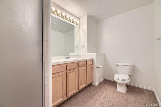 bathroom with toilet, a textured ceiling, an enclosed shower, and vanity