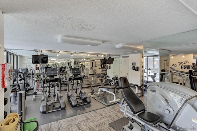 exercise room featuring a textured ceiling