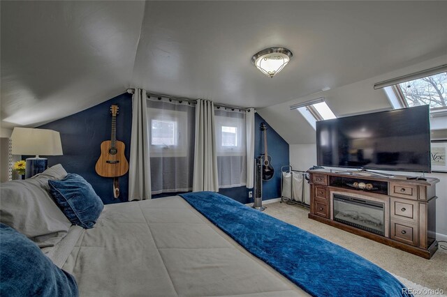 carpeted bedroom with baseboards, multiple windows, and vaulted ceiling