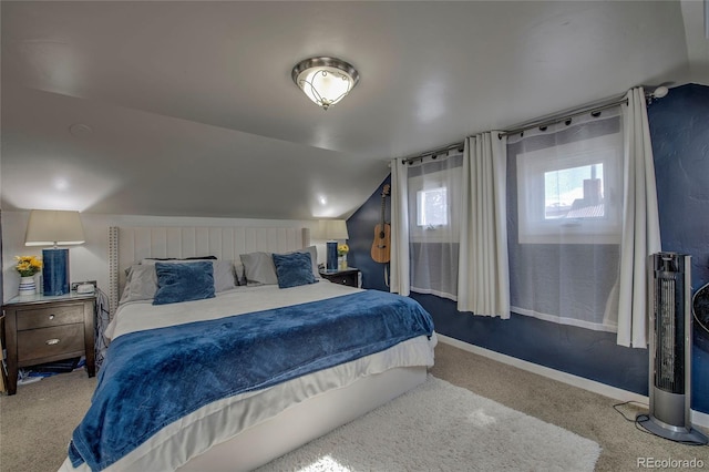 bedroom with carpet floors, baseboards, and vaulted ceiling