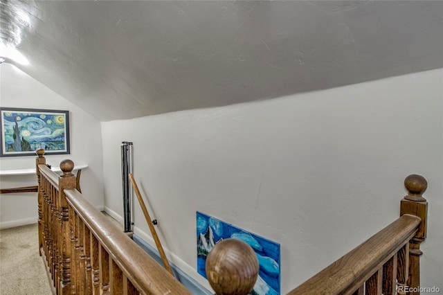 hall featuring an upstairs landing, carpet flooring, and vaulted ceiling