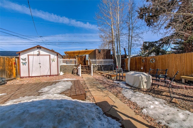 view of yard featuring a fenced backyard, an outdoor structure, and a storage unit