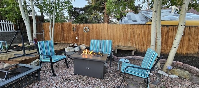 view of patio / terrace featuring an outdoor fire pit and fence