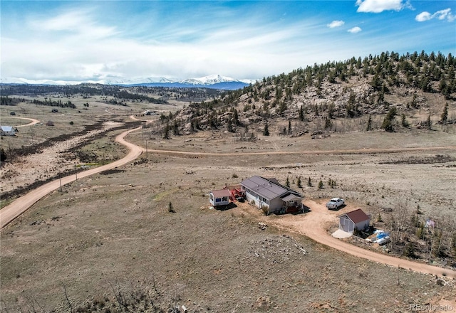 birds eye view of property featuring a mountain view and a rural view