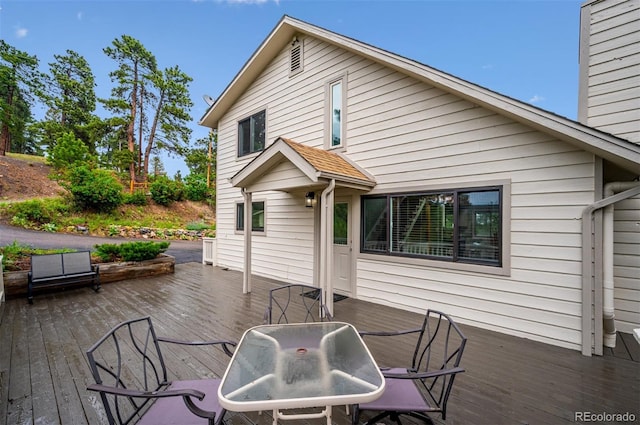 9189 Fallen Rock Rd, Conifer, CO 80433 - wooden deck with outdoor dining area and grilling area