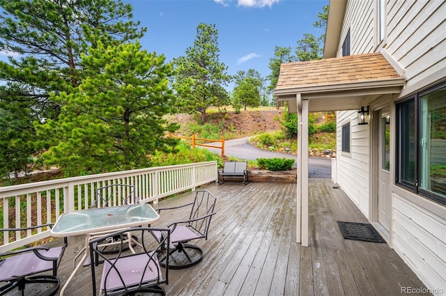 9189 Fallen Rock Rd, Conifer, CO 80433 - wooden deck with outdoor dining space and grilling area
