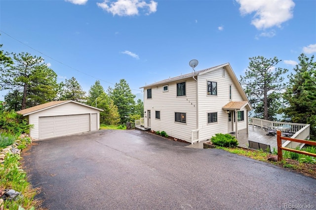 9189 Fallen Rock Rd, Conifer, CO 80433 - view of side of home with an outbuilding, a garage, and a wooden deck