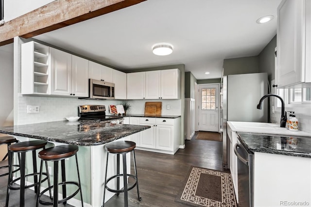 9189 Fallen Rock Rd, Conifer, CO 80433 - kitchen featuring stainless steel appliances, a peninsula, open shelves, white cabinetry, and dark wood-style floors