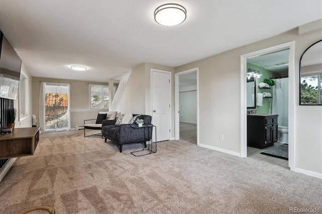9189 Fallen Rock Rd, Conifer, CO 80433 - living room featuring light carpet and stairs