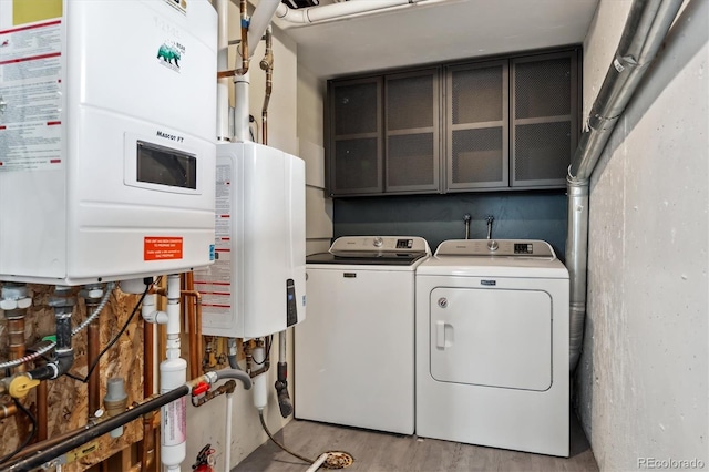 9189 Fallen Rock Rd, Conifer, CO 80433 - laundry area with tankless water heater, washer and dryer, and wood finished floors