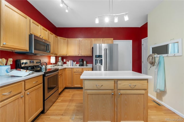 10262 Spotted Owl Ave, Highlands Ranch, CO 80129 - kitchen featuring appliances with stainless steel finishes, light wood finished floors, light countertops, and light brown cabinetry