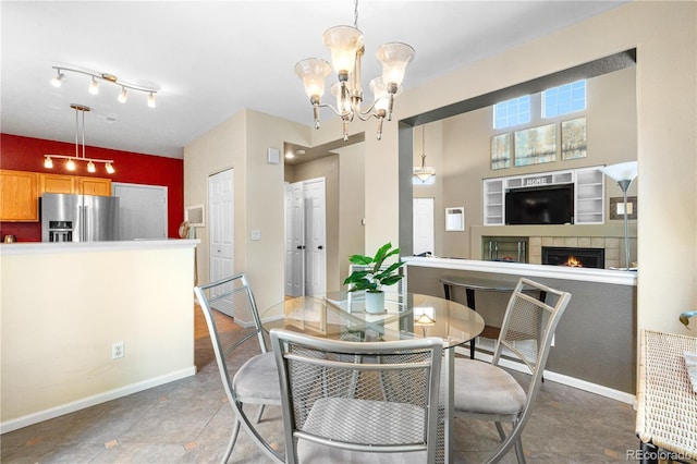 10262 Spotted Owl Ave, Highlands Ranch, CO 80129 - dining area featuring a chandelier and a fireplace
