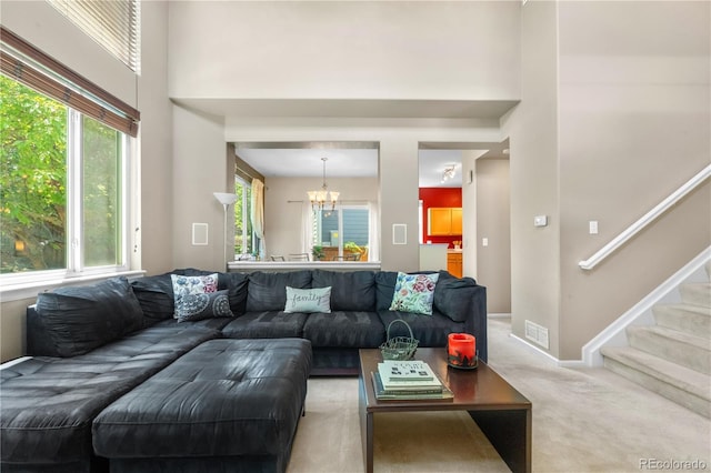 10262 Spotted Owl Ave, Highlands Ranch, CO 80129 - living room with a chandelier, carpet flooring, stairs, and a towering ceiling