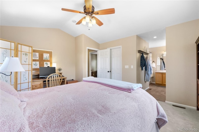 10262 Spotted Owl Ave, Highlands Ranch, CO 80129 - bedroom featuring light colored carpet, vaulted ceiling, ceiling fan, and connected bathroom
