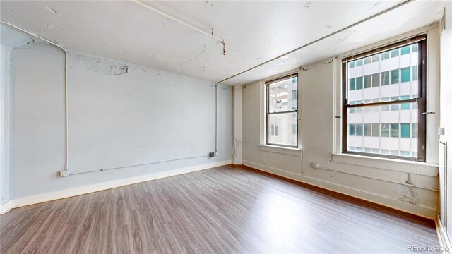 444 17th St Unit 301, Denver, CO 80202 - unfurnished room with wood finished floors and baseboards