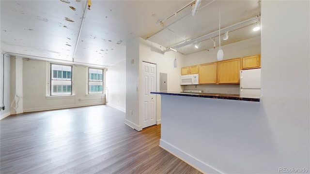 444 17th St Unit 301, Denver, CO 80202 - kitchen with white appliances, dark countertops, wood finished floors, baseboards, and electric panel