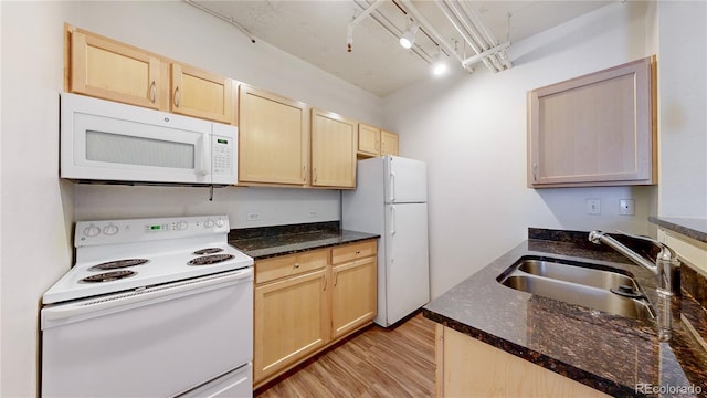444 17th St Unit 301, Denver, CO 80202 - kitchen with white appliances, light brown cabinetry, a sink, and light wood-style floors