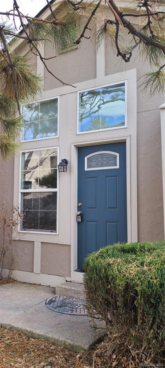 entrance to property featuring stucco siding