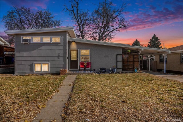 1654 S Perry St, Denver, CO 80219 - split level home with a front yard, an attached carport, and cooling unit