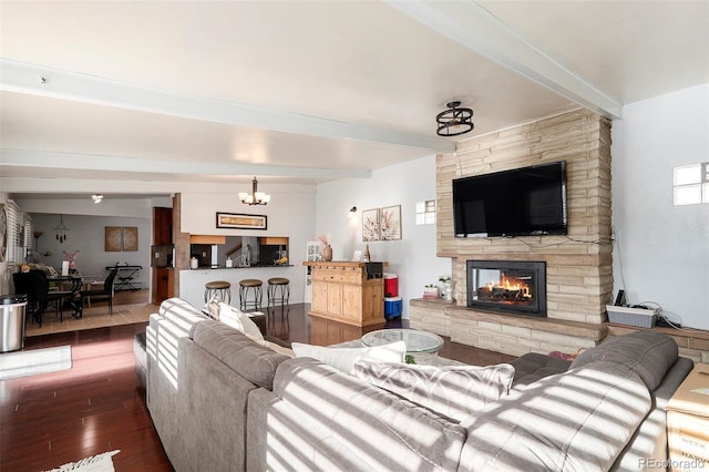 1654 S Perry St, Denver, CO 80219 - living room with beam ceiling, wood-type flooring, a fireplace, and a chandelier