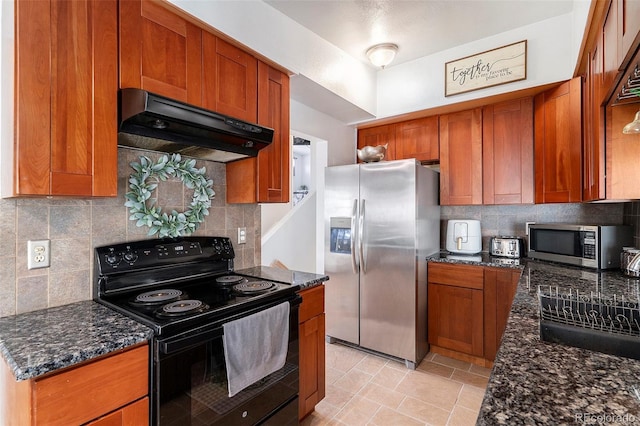 kitchen featuring appliances with stainless steel finishes, dark stone countertops, backsplash, and extractor fan