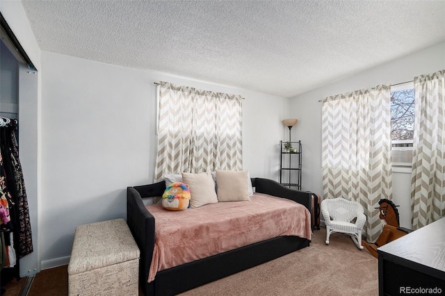 carpeted bedroom with a textured ceiling and cooling unit