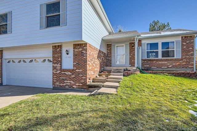 view of front of property featuring a garage and a front lawn