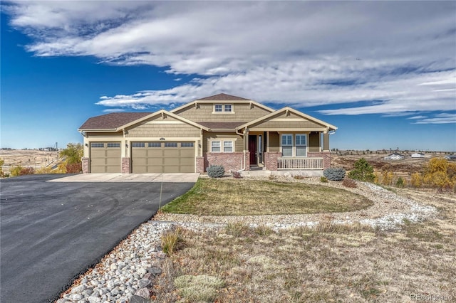 craftsman-style home with concrete driveway, covered porch, brick siding, and an attached garage