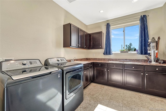 laundry area featuring washing machine and dryer, cabinet space, a sink, and recessed lighting